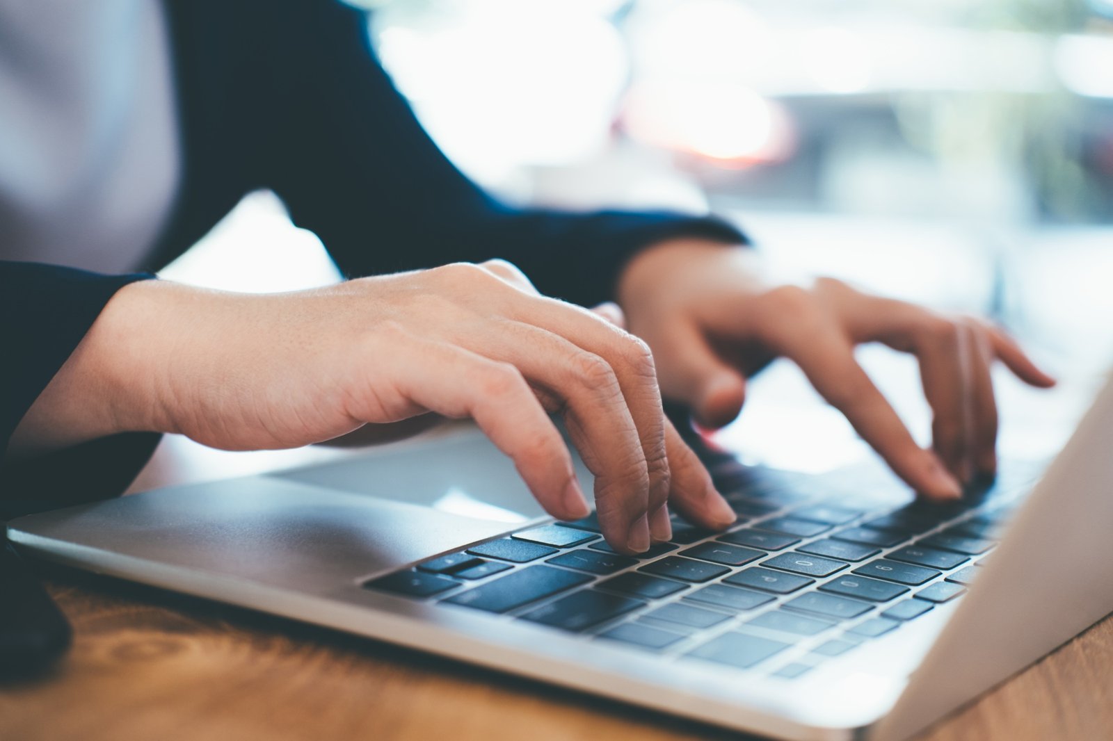 Portrait of business professional lady working at computer in the office or networking space.